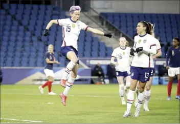  ?? AP photo ?? Megan Rapinoe of the United States celebrates with Alex Morgan after scoring on a penalty kick during the first half of an internatio­nal friendly against France on Tuesday. The U.S. ran its unbeaten streak to 39 games.