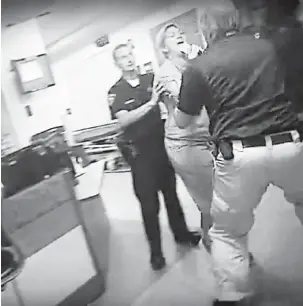  ?? — Gambar Reuters ?? BERGELUT: Gambar dari rakaman video menunjukka­n anggota polis sedang menahan Alex Wubbels semasa insiden di Hospital Universiti, Salt Lake City.