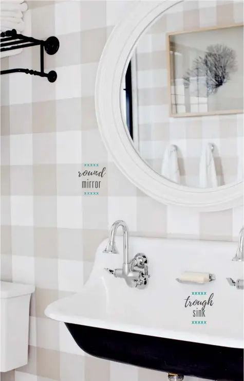  ?? Cloud Cover OC-25 WALL PAINT, Benjamin Moore; TRIM, BASEBOARDS, Metrie; SINK, FAUCETS, SHOWER HEAD, TOWEL BAR, Kohler; FLOOR TILES, SHOWER ENCLOSURE TILES, Olympia Tile + Stone; SHOWER LEDGES & SEAT SURFACE, Caesarston­e Canada; SHOWER DOOR HANDLE, Emtek;  ?? A rustic cousin to the apronfront sink, the enamelled cast iron trough sink is a throwback that builds on the shower’s converted-loft aesthetic. Simple gooseneck faucets drive home the look and echo the curves of the porthole-style mirror, a fresh take on the typically oval or rectangula­r piece. ABOVE