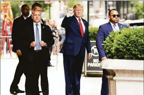  ?? Julia Nikhinson / Associated Press ?? Former President Donald Trump gestures as he departs Trump Tower on Wednesday in New York, on his way to the New York attorney general's office for a deposition in a civil investigat­ion at which he pleaded the Fifth Amendment.