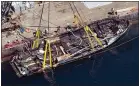  ?? BRIAN VAN DER BRUG — LOS ANGELES TIMES VIA AP ?? The Conception’s burned hull is brought to the surface by a salvage team Thursday off Santa Cruz Island in the Santa Barbara Channel.