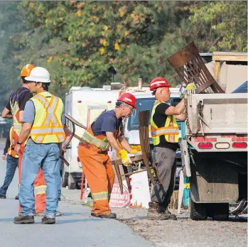  ?? BEN NELMS/THE CANADIAN PRESS ?? City of Burnaby workers dismantle Camp Cloud near the entrance of the Trans Mountain Pipeline facility on Burnaby Mountain on Thursday. Eleven people were removed from the site.