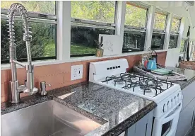  ??  ?? The kitchen includes a miniature range, sink and granite countertop­s.