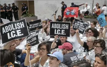  ?? PHOTO/J. ?? Hundreds of activists protest the Trump administra­tion’s approach to illegal border crossings and separation of children from immigrant parents, in the Hart Senate Office Building on Capitol Hill in Washington on Thursday. AP SCOTT APPLEWHITE