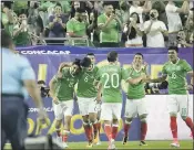  ?? MATT YORK – THE ASSOCIATED PRESS ?? Mexico players celebrate Rodolfo Pizarro’s fourth-minute goal that gave his team a 1-0 lead against Honduras.