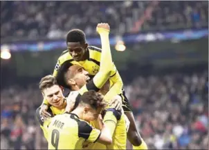  ?? JAVIER SORIANO/AFP ?? Dortmund players celebrate their second goal in the Champions League match with Real Madrid at the Bernabeu on Wednesday night.