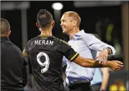  ?? ADAM CAIRNS / COLUMBUS DISPATCH ?? Columbus captain Wil Trapp, who captained the U.S. eight times this year, said new U.S. men’s national team coach Gregg Berhalter (shown here with Justin Meram) was remarkable for his nonstop eye contact with players.