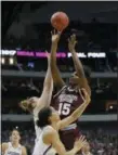  ?? TONY GUTIERREZ — THE ASSOCIATED PRESS ?? Mississipp­i State center Teaira McCowan shoots over Connecticu­t guard Gabby Williams, front, and forward Katie Lou Samuelson.