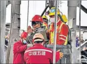  ?? REUTERS ?? Rescue workers help a miner as he is brought to the surface at the Hushan gold mine in Qixia, Shandong province, China.