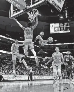  ?? Justin Ford / Getty Images ?? Stephen Curry, center, and the Warriors have had many of the NBA’s intriguing storylines in the first half of the season. Ja Morant also has been a bright spot.