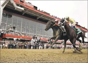  ?? Matt Slocum / Associated Press ?? In this May 20, 2017, file photo, Cloud Computing, left, leads Classic Empire to win the 142nd Preakness Stakes horse race at Pimlico RaceCourse in Baltimore. Pimlico is all gussied up again this week, ready to host the Preakness on a day that will...