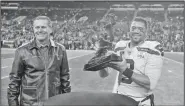  ?? AP/TED S. WARREN ?? Seattle Seahawks quarterbac­k Russell Wilson (3) stands with former team quarterbac­k Steve Largent Monday after being given the “Steve Largent Award” before an NFL football game against the Minnesota Vikings in Seattle.
