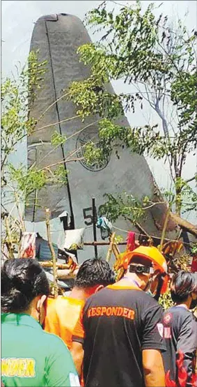  ??  ?? Rescue workers arrive as smoke billows from the wreckage of a Philippine Air Force C-130 transport plane after it crashed yesterday near the airport in Jolo town, Sulu province on the southern island of Mindanao.