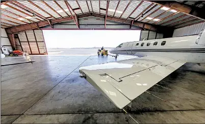  ?? Arkansas Democrat-Gazette/JOHN SYKES JR. ?? A business jet is towed from a hangar last week at North Little Rock Municipal Airport.