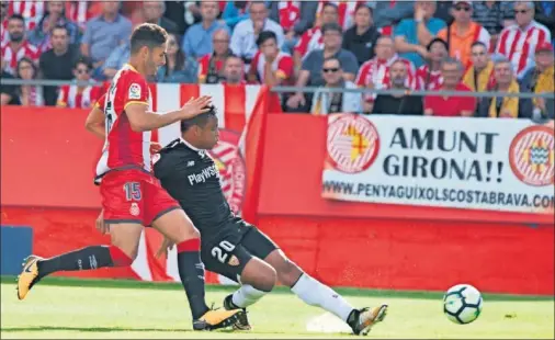  ??  ?? EL GOL SEVILLISTA. Muriel dispara a portería ante la presión de Juanpe en la acción que supuso el 0-1 en el encuentro disputado en Montilivi.