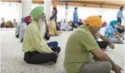  ?? ?? Jairam Singh Kahlon, left, president of the gurdwara’s board, attends prayers June 12.