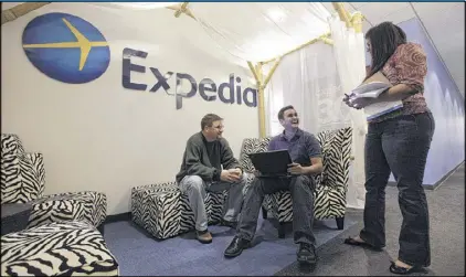  ?? AP ?? Expedia analytics workers Mike Brown (left), Saurin Pandya and Prashanti Tata chat in an alcove set up for employees at its offices in Bellevue, Wash. Expedia said Thursday that it is buying rival online travel site Orbitz. The deal comes less than a month after Expedia announced the acquisitio­n of Travelocit­y.