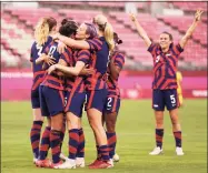  ?? Francois Nel / Getty Images ?? The United States celebrates a goal against Australia during the bronze medal match at the Olympics on Thursday.