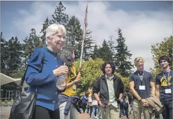  ?? Photograph­s by David Butow For The Times ?? NEW UC BERKELEY Chancellor Carol T. Christ, left, who took the helm in July as the first woman to lead California’s oldest public university, greets new arrivals touring campus during freshman orientatio­n.