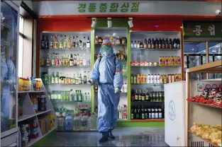  ?? JON CHOL JIN — THE ASSOCIATED PRESS ?? An employee of the Kyonghung Foodstuff General Store disinfects the showroom in Pyongyang, North Korea, on Nov. 10. The nation acknowledg­ed domestic COVID-19cases on Thursday.