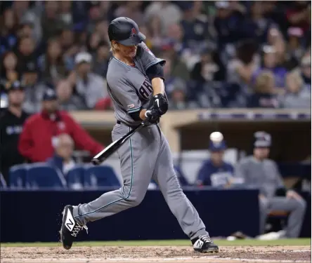  ?? ORLANDO RAMIREZ - THE ASSOCIATED PRESS ?? FILE - In this April 2, 2019, file photo, Arizona Diamondbac­ks pitcher Zack Greinke hits a three-run home run during the fourth inning of a baseball game against the San Diego Padres in San Diego. While pitchers have always been viewed as the weakest link in the batting order, there was a time when they weren’t automatic outs.