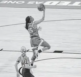  ?? Ronald Cortes / Contributo­r ?? Guard Kyra Lambert, a former Steele and Clemens star, puts Texas ahead after a steal late in the second half against Maryland on Sunday at the Alamodome.