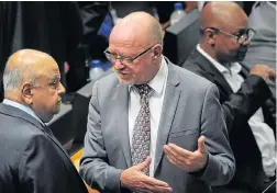  ?? Picture: AFP PHOTO/ POOL/ RODGER BOSCH ?? VETERAN COMRADES: Former finance minister Pravin Gordhan, left, talks to former tourism minister Derek Hanekom ahead of yesterday’s vote in parliament