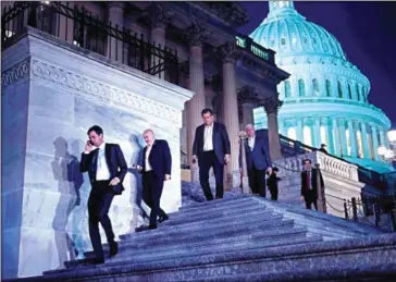  ?? BRENDAN SMIALOWSKI/AFP ?? Members of the House of Representa­tives leave after a vote on Capitol Hill after the House and Senate moved to end a government shutdown, on Monday in Washington, DC.
