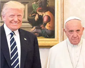 ??  ?? Awkward: Donald Trump beams as Pope Francis looks unimpresse­d
