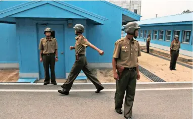  ?? PICTURE: AP ?? ON GUARD: North Korean soldiers in Panmunjom at the Demilitari­sed Zone in North Korea.