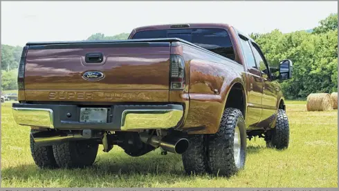  ??  ?? Fitting for a dually, the Diamond Eye dual-exit exhaust system appears right at home on Ken’s F-350. The 4-inch diameter aluminized system is capped off with 7-inch tips and linked to the turbo via a 3.5-inch downpipe. Also notice the ’08-’10 model tailgate.