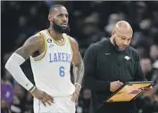  ?? Abbie Parr Associated Press ?? LeBRON JAMES, left, and coach Darvin Ham need to find answers quickly for the 0-5 Lakers.