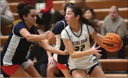  ?? PHOTO BY ANDY HOLZMAN ?? Notre Dame's Riley Mann looks to pass under pressure from Natalie Patrick-Aguiar of Chaminade in a Mission League game won by Notre Dame on Thursday.