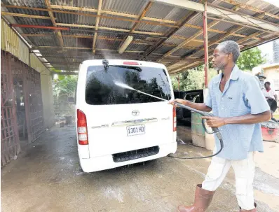 ?? IAN ALLEN/PHOTOGRAPH­ER ?? Anthony Williams, a car wash operator in Orangefiel­d, St Catherine, says he has to spend more than $40,000 per month purchasing water to sustain his business.