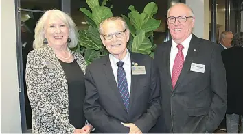  ?? ?? Drouin Rotary Club president Pauline Maunder (left) and president elect Mike Kelleher (right) with Keith Pretty who presented the club’s history at the anniversar­y dinner held at the Drouin Golf Club last week.