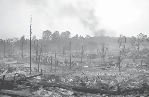  ?? — Gambar AFP ?? PADANG JARAK PADANG TEKUKUR: Asap berkepul dari sekitar kawasan kejiranan yang musnah terbakar di Santa Rosa, California kelmarin.