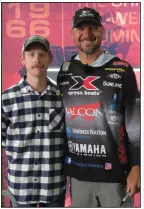  ?? (Arkansas Democrat-Gazette/Bryan Hendricks) ?? Ryan Kemp (left) is proud of having built Jason Christie’s championsh­ip winning Xpress bass boat.