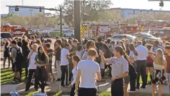  ?? FLORIDA SUN- SENTINEL VIA AP JOHN MCCALL/ SOUTH ?? Students are released from lockdown following a shooting Wednesday at Marjory Stoneman Douglas High School in Parkland, Fla.