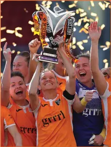  ??  ?? Leanne Ross lifts the Championsh­ip trophy in Cumbernaul­d for Glasgow City's 14th consecutiv­e Scottish Women's Premier League title on a dramatic last day of the season