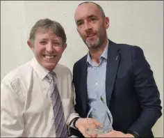  ?? ?? Bill Porter presents Glendaloug­h AC’s John Conway with the masters men’s athlete of the year award.