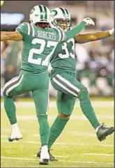  ?? AP ?? Cornerback Darryl Roberts (27), strong safety Jamal Adams (33) and rest of Jet defenders become social media stars thanks to dance break during victory over Bills.