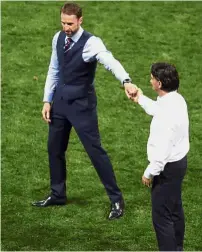  ??  ?? All the best: England coach Gareth Southgate (left) and Croatia coach Zlatko Dalic shaking hands at the end of the semi-final match on Wednesday. — AP