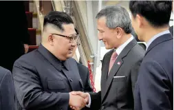  ?? PICTURE: AP ?? MEET AND GREET: North Korean leader Kim Jong Un, left, is greeted by Singapore Minister for Foreign Affairs Dr Vivian Balakrishn­an at the Changi Internatio­nal Airport in Singapore on Sunday, ahead of today’s summit with President Donald Trump.