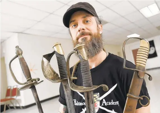  ??  ?? Dai Andrews of the Baltimore Academy of Defence is pictured with a collection of antique military swords.