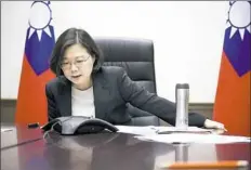  ?? Taiwan Presidenti­al Office via AP ?? Taiwan’s President Tsai Ing-wen speaks Friday with Presidente­lect Donald Trump through a speaker phone in Taipei.