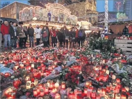  ?? Photo: Sean Gallup/Getty Images ?? Safe: A memorial in a German market for the 12 killed when a truck ploughed into them. Events such as this are behind a bid for a European security plan — and possibly a defence plan.