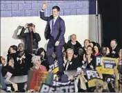  ?? Charlie Neibergall Associated Press ?? PETE BUTTIGIEG greets his supporters at a caucus night campaign rally in Des Moines.