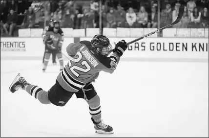  ?? COURTESY PHOTO ?? Defenseman Alec Johnson fires a shot in a UNLV hockey game earlier this season. UNLV has advanced to the ACHA’S Division I National Championsh­ip tournament in Boston.