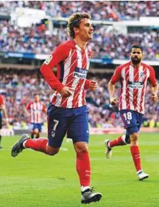  ?? AP ?? Atletico Madrid’s Antoine Griezmann celebrates after scoring the first goal against Real Madrid during the La Liga match at the Santiago Bernabeu stadium in Madrid on Sunday.