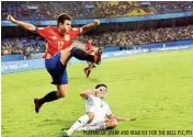  ?? PLAYERS OF SPAIN AND IRAN VIE FOR THE BALL PIC/PTI ??